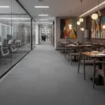 Luxury Dubai gym reception with a curved wooden desk, grey carpet, and floor-to-ceiling city views.