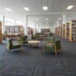 Modern Dubai library with green seating and bookshelves.