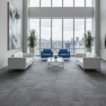 Modern Dubai office lounge featuring blue and white seating on a grey textured carpet.