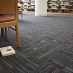 Textured library carpet in Dubai with a book on the floor.